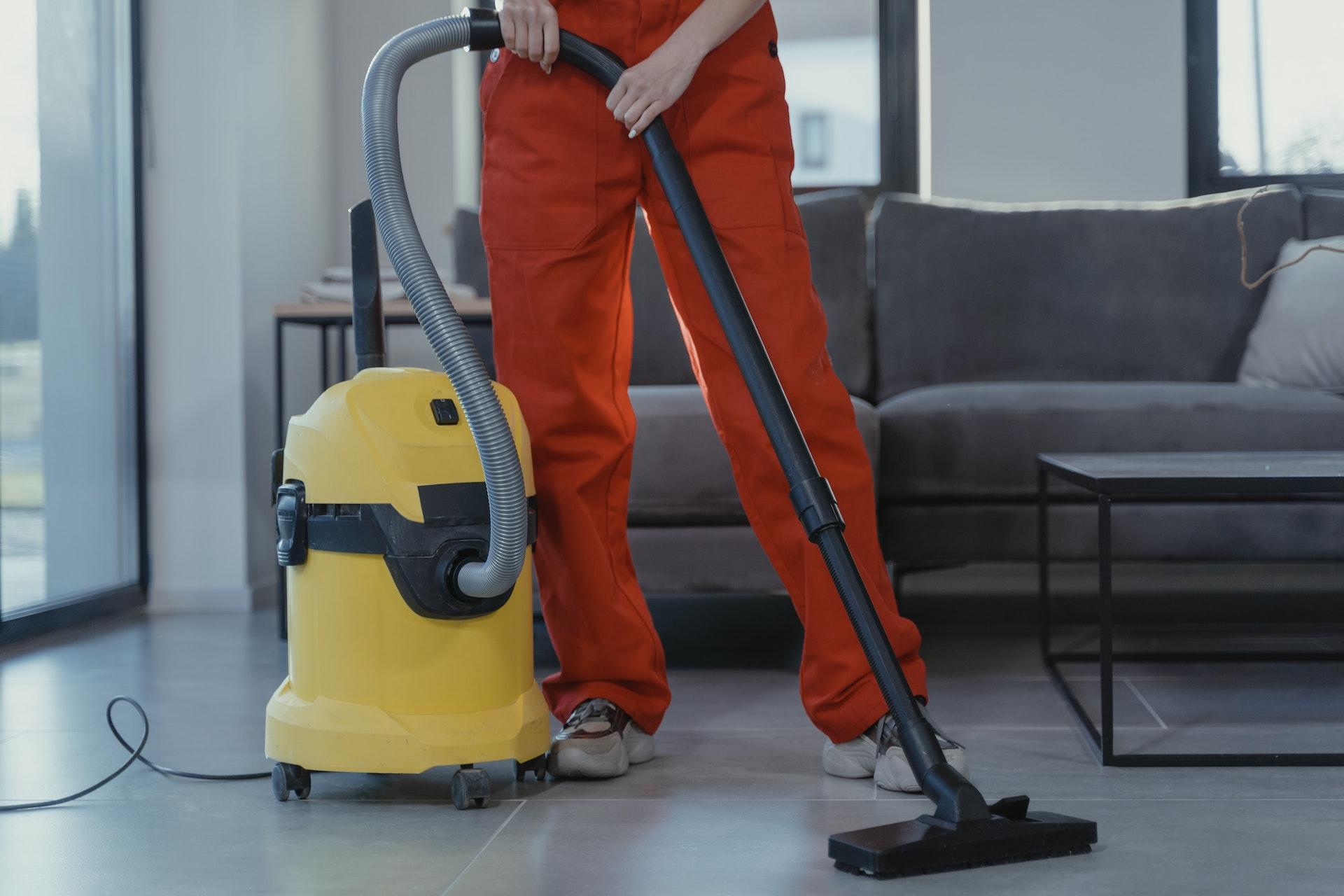 Cleaner wiping a modern kitchen counter
